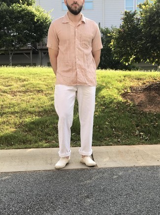 Pink Short Sleeve Shirt Outfits For Men: A pink short sleeve shirt and white chinos are amazing menswear essentials that will integrate really well within your current rotation. Let your sartorial chops really shine by finishing this ensemble with a pair of white canvas slip-on sneakers.