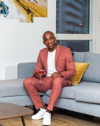 Pink Suit Smart Casual Outfits: Go for smart style in a pink suit and a white crew-neck t-shirt. Finishing with a pair of white and black leather low top sneakers is a surefire way to infuse a sense of stylish effortlessness into your look.
