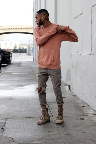 Pink Sweatshirt Outfits For Men: Reach for a pink sweatshirt and grey ripped jeans to create a truly stylish and modern casual outfit. Balance out this look with a smarter kind of shoes, like these brown suede casual boots.