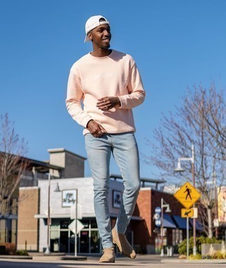 Pink Sweatshirt Outfits For Men: Pair a pink sweatshirt with light blue skinny jeans for an easy-to-wear menswear style. Puzzled as to how to complement your outfit? Wear tan suede chelsea boots to class it up.