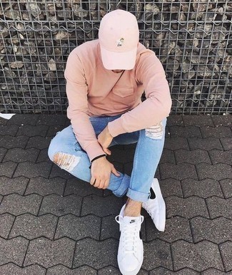 Men's Pink Sweatshirt, Light Blue Ripped Skinny Jeans, White and Black Leather Low Top Sneakers, Pink Baseball Cap