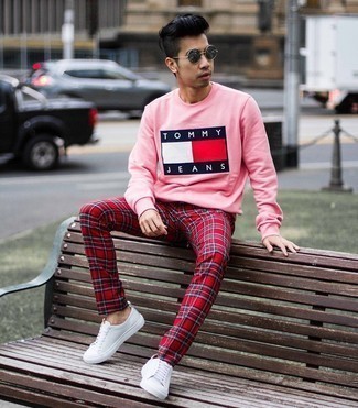 Pink Print Sweatshirt Outfits For Men: For an ensemble that brings comfort and dapperness, pair a pink print sweatshirt with red plaid chinos. White canvas low top sneakers will be a stylish addition to this getup.