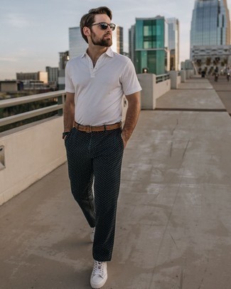 Tan Leather Belt Outfits For Men: You'll be amazed at how easy it is for any man to put together a relaxed casual getup like this. Just a white polo and a tan leather belt. A pair of white leather low top sneakers easily ups the classy factor of any ensemble.