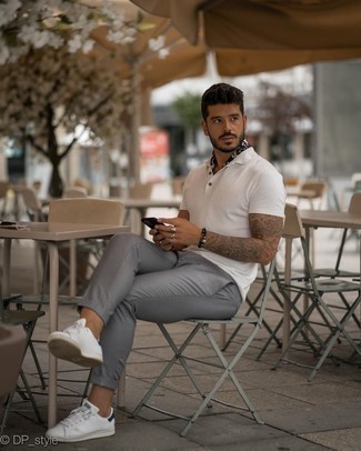 White and Navy Leather Low Top Sneakers Outfits For Men: This combo of a white polo and grey chinos is an exciting idea for when it's time to go casual. White and navy leather low top sneakers pull the ensemble together.