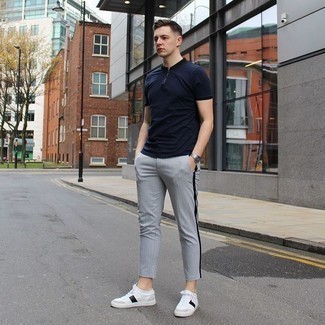White and Black Leather Shoes with Pants Outfits For Men: A navy polo and pants are among the fundamental elements in any modern gentleman's versatile casual sartorial arsenal. Add white and black leather low top sneakers to the equation to easily up the wow factor of this ensemble.