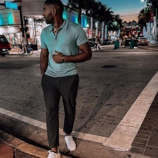 Green Polo Outfits For Men: A green polo and black chinos are a pairing that every sartorially savvy gent should have in his off-duty arsenal. Complete this look with white and black leather low top sneakers and the whole ensemble will come together quite nicely.
