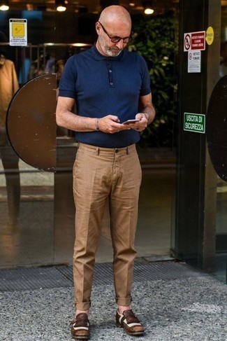 Dark Brown Leather Monks Outfits: This relaxed combination of a navy polo and khaki chinos is extremely easy to throw together in no time flat, helping you look sharp and ready for anything without spending too much time searching through your closet. Channel your inner David Beckham and polish off your outfit with dark brown leather monks.