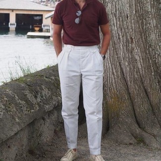 White Dress Pants Outfits For Men: This look with a burgundy polo and white dress pants isn't so hard to score and is open to more sartorial experimentation. Punch up this look with a pair of beige canvas low top sneakers.