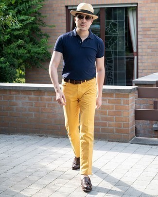 Green-Yellow Jeans Outfits For Men: Team a navy polo with green-yellow jeans for both on-trend and easy-to-style look. To give this getup a more elegant aesthetic, complement this outfit with a pair of dark brown leather tassel loafers.