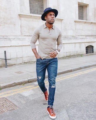 Beige Polo Neck Sweater Outfits For Men: This pairing of a beige polo neck sweater and blue ripped jeans is hard proof that a simple casual outfit can still look incredibly sharp. Let your outfit coordination prowess really shine by complementing this ensemble with a pair of tobacco leather low top sneakers.