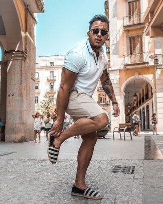 Tan Shorts Outfits For Men: Marry a white polo with tan shorts for both sharp and easy-to-wear outfit. Navy and white horizontal striped canvas espadrilles will tie this full look together.