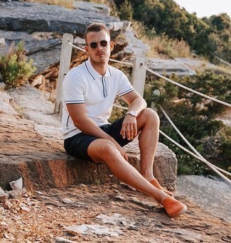 Orange Slip-on Sneakers Outfits For Men: Consider wearing a white polo and navy shorts for a casually edgy and fashionable getup. Add a pair of orange slip-on sneakers to this outfit and you're all done and looking spectacular.