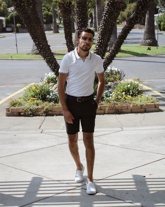 Black Shorts Outfits For Men: You're looking at the definitive proof that a white polo and black shorts are amazing when teamed together in a casual ensemble. When not sure as to the footwear, introduce white canvas slip-on sneakers to the equation.