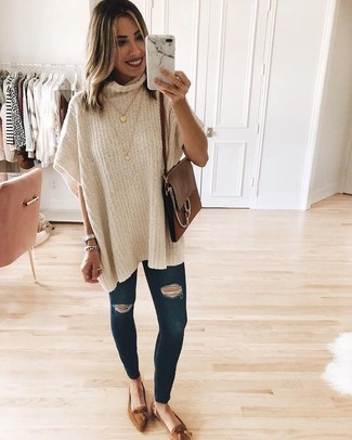 Tassel Loafers Outfits For Women: The combination of a beige poncho and navy ripped skinny jeans makes for a solid casual look. If you wish to effortlessly spruce up this look with shoes, add a pair of tassel loafers to the equation.
