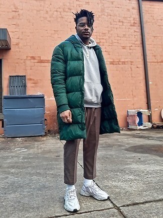 Dark Green Puffer Coat Outfits For Men: This laid-back combination of a dark green puffer coat and brown chinos comes to rescue when you need to look casual and cool but have no time to spare. White athletic shoes are an easy way to infuse a sense of stylish nonchalance into your outfit.