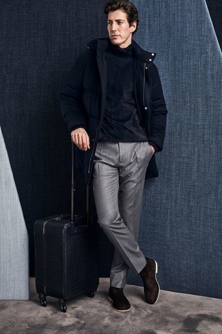 Suitcase Outfits For Men: Team a navy puffer coat with a suitcase for a casual getup with a city style finish. Inject your outfit with an added touch of elegance by rocking dark brown suede chelsea boots.