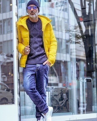 Men's Yellow Puffer Jacket, Navy Cable Sweater, Navy Jeans, White Canvas Low Top Sneakers