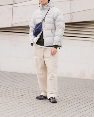 Bag Outfits For Men: This is definitive proof that a white puffer jacket and a bag look amazing when married together in a relaxed casual ensemble. Our favorite of a myriad of ways to complete this ensemble is with a pair of charcoal athletic shoes.