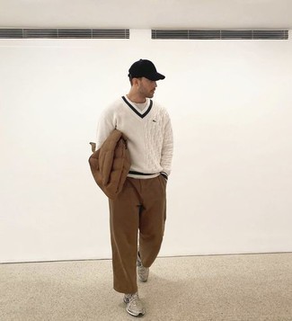 White Crew-neck Sweater Chill Weather Outfits For Men: If you're seeking to take your casual game to a new level, rock a white crew-neck sweater with brown chinos. Finishing with grey athletic shoes is the simplest way to add an easy-going vibe to this getup.