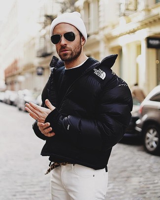 Black Puffer Jacket Outfits For Men: The ultimate choice for casually classic menswear style? A black puffer jacket with white jeans.