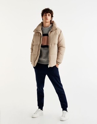 Puffer Jacket Outfits For Men: Uber dapper, this relaxed combo of a puffer jacket and navy sweatpants will provide you with wonderful styling possibilities. White canvas low top sneakers look wonderful complementing this look.