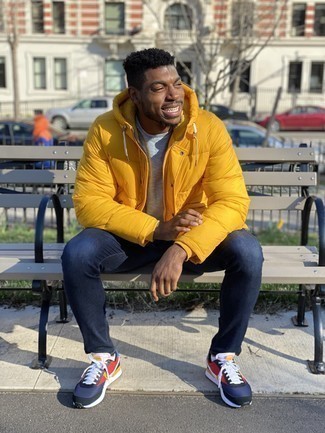 Orange Puffer Jacket Outfits For Men: Parade your sartorial-savvy side by opting for an orange puffer jacket and navy skinny jeans. Add a carefree vibe to this outfit by finishing off with navy and red athletic shoes.