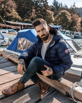 604+ Casual Cold Weather Outfits For Men: Pairing a navy puffer jacket with navy skinny jeans is an amazing choice for a casual but stylish ensemble. Get a bit experimental with shoes and smarten up your look by rounding off with a pair of brown leather casual boots.