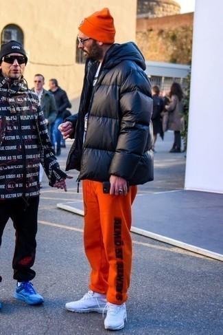 Orange Sweatpants Outfits For Men: A black puffer jacket and orange sweatpants are great menswear pieces to have in the casual part of your wardrobe. Break up your outfit by wearing a pair of white athletic shoes.