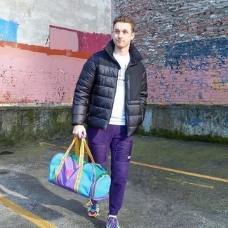 Duffle Bag Outfits For Men: Pair a black puffer jacket with a duffle bag to create an interesting and city casual ensemble. We're loving how complete this outfit looks when rounded off by multi colored athletic shoes.