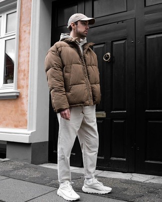 Brown Puffer Jacket Outfits For Men: A brown puffer jacket and white corduroy chinos are essential in any man's functional closet. White athletic shoes bring a casual aesthetic to the look.