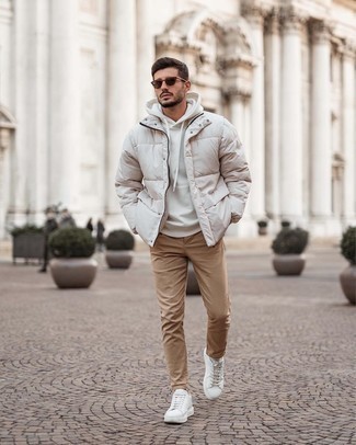 White Hoodie Outfits For Men: Go for a white hoodie and khaki chinos for comfort dressing with a fashionable spin. Introduce white leather low top sneakers to the equation for maximum style.