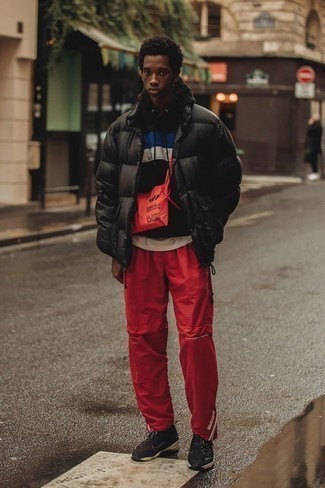 Red Canvas Messenger Bag Outfits: This combo of a black puffer jacket and a red canvas messenger bag is definitive proof that a pared down casual ensemble doesn't have to be boring. Our favorite of a great number of ways to finish this ensemble is black athletic shoes.