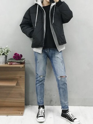 Black Puffer Jacket Outfits For Men: Solid proof that a black puffer jacket and light blue ripped jeans are amazing when married together in a laid-back outfit. Let your sartorial expertise really shine by finishing off this outfit with black and white canvas low top sneakers.