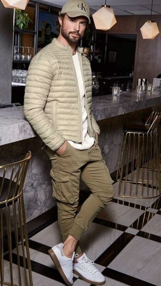 Beige Puffer Jacket Outfits For Men: Marrying a beige puffer jacket with olive cargo pants is an on-point idea for an off-duty yet on-trend outfit. Complement your look with a pair of white canvas low top sneakers to effortlessly turn up the style factor of your getup.