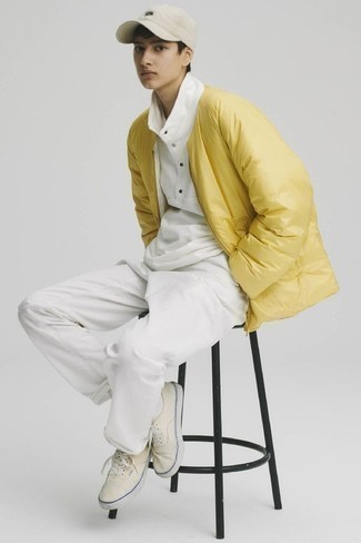 26 Cold Weather Outfits For Men In Their Teens: The styling capabilities of a mustard puffer jacket and white sweatpants ensure they will be on permanent rotation. Add yellow canvas low top sneakers to your ensemble to pull the whole outfit together. Overall, a good demonstration of teenage fashion.