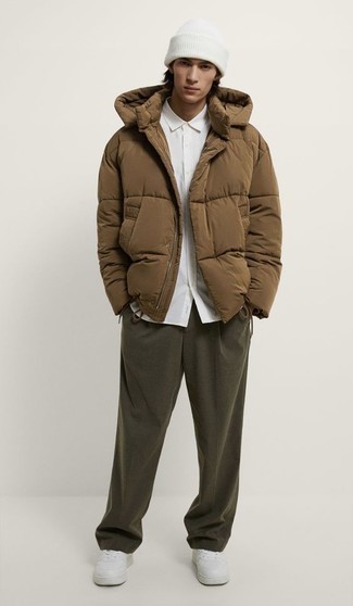 1200+ Smart Casual Outfits For Men: Such must-haves as a brown puffer jacket and olive chinos are the perfect way to inject some refinement into your current off-duty rotation. A pair of white leather low top sneakers easily amps up the appeal of this look.