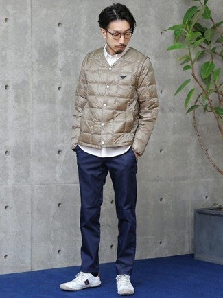 Tan Puffer Jacket Outfits For Men: For a smart casual look, reach for a tan puffer jacket and navy chinos — these two pieces go pretty good together. Bring casualness to your ensemble with a pair of white print canvas low top sneakers.