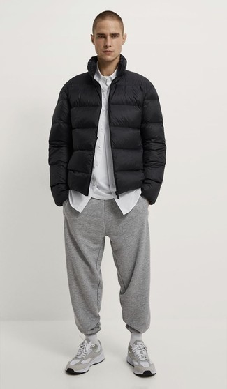 500+ Chill Weather Outfits For Men: If you like classic combos, then you'll like this combo of a black puffer jacket and grey sweatpants. Complement this look with grey athletic shoes to infuse a touch of stylish effortlessness into your look.