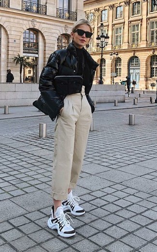 Beige Tapered Pants Outfits For Women: A black puffer jacket and beige tapered pants are a savvy pairing to have in your current repertoire. Why not take a more relaxed approach with shoes and add a pair of white and black athletic shoes to the mix?