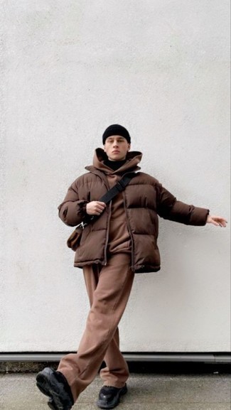 Puffer Jacket Outfits For Men: Go for a pared down yet sharp choice by wearing a puffer jacket and a black turtleneck. You could perhaps get a bit experimental on the shoe front and complete this ensemble with black athletic shoes.