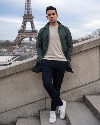 Dark Green Raincoat Outfits For Men: This casual combo of a dark green raincoat and navy chinos can take on different moods depending on how you style it. Complement your ensemble with a pair of white canvas low top sneakers and the whole ensemble will come together perfectly.