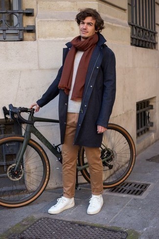 Raincoat Outfits For Men: Why not reach for a raincoat and khaki chinos? As well as super comfortable, these items look nice paired together. White canvas low top sneakers are the perfect accompaniment for your getup.