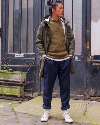 Olive Raincoat Outfits For Men: This relaxed casual combination of an olive raincoat and navy sweatpants is a winning option when you need to look great but have zero time. Introduce white canvas low top sneakers to this look and you're all done and looking boss.