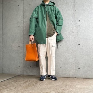 Men's Outfits 2021: For a casually dapper outfit, go for a green raincoat and white cargo pants — these pieces fit really well together. For times when this ensemble appears all-too-fancy, tone it down by finishing off with a pair of navy and white athletic shoes.