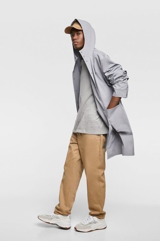 Charcoal Raincoat Outfits For Men: Why not try pairing a charcoal raincoat with khaki chinos? As well as super comfortable, these pieces look awesome when teamed together. Beige athletic shoes will give a touch of stylish effortlessness to an otherwise all-too-safe ensemble.