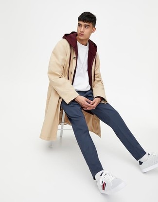 Beige Raincoat Outfits For Men: This casual pairing of a beige raincoat and navy chinos is a foolproof option when you need to look casually cool in a flash. A pair of white leather low top sneakers can integrate smoothly within a great deal of ensembles.