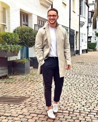 Beige Raincoat Outfits For Men: Exhibit your prowess in menswear styling in this casual pairing of a beige raincoat and navy chinos. Add a pair of white canvas low top sneakers to the mix and the whole ensemble will come together brilliantly.