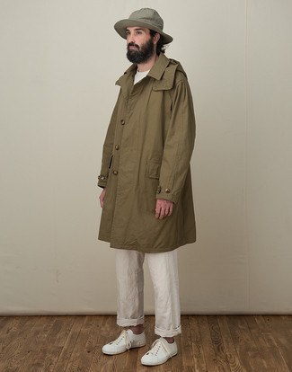 Olive Raincoat Outfits For Men: An olive raincoat and white chinos are a good combination to have in your menswear collection. This look is finished off really well with white canvas low top sneakers.