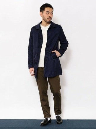 Raincoat Outfits For Men: Try pairing a raincoat with dark brown chinos to achieve an interesting and current relaxed ensemble. Black leather loafers are an effective way to breathe a touch of polish into this look.