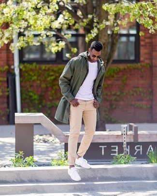 Olive Raincoat Outfits For Men: This combo of an olive raincoat and beige chinos is on the casual side but also ensures that you look on-trend and truly dapper. On the shoe front, this look is completed perfectly with white canvas low top sneakers.